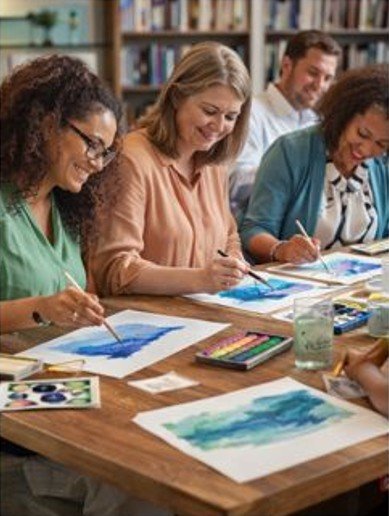 Educators and adult participants taking part in a guided creative art session in an educational or institutional group setting.
