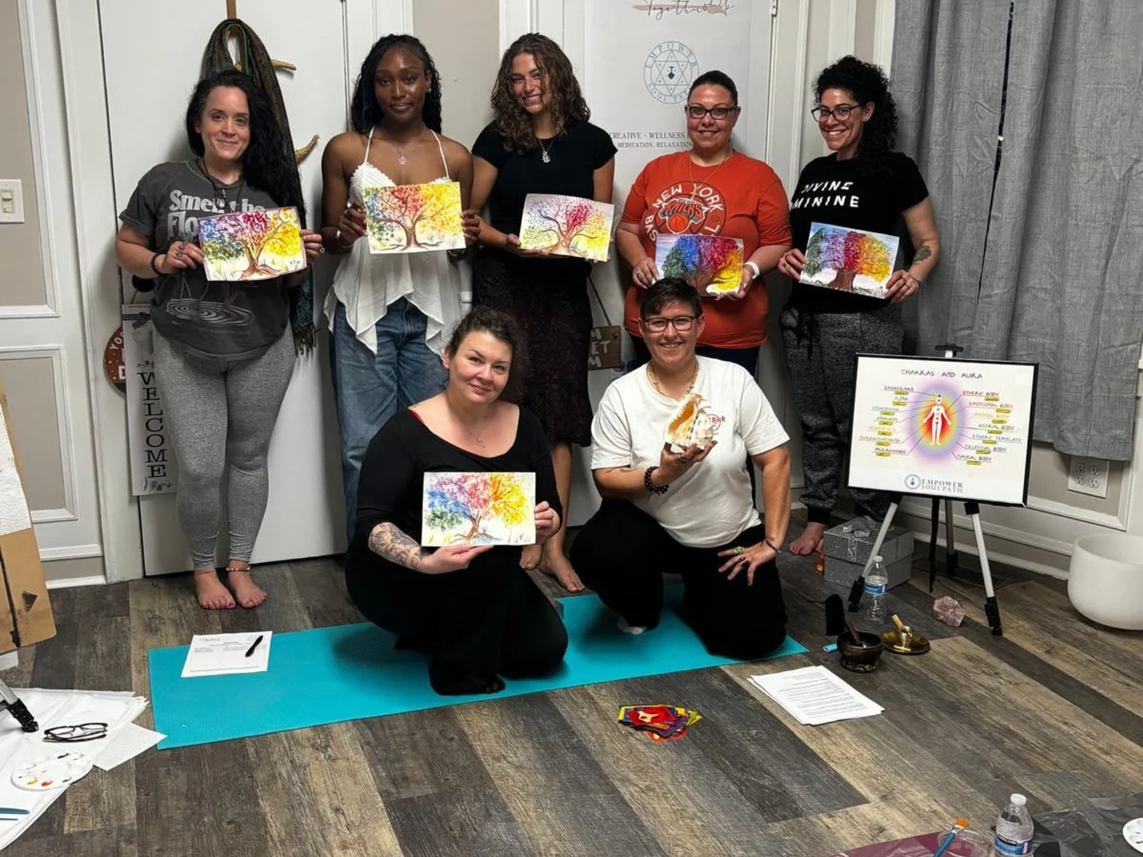 Group showing their artwork after a mindful watercolor workshop